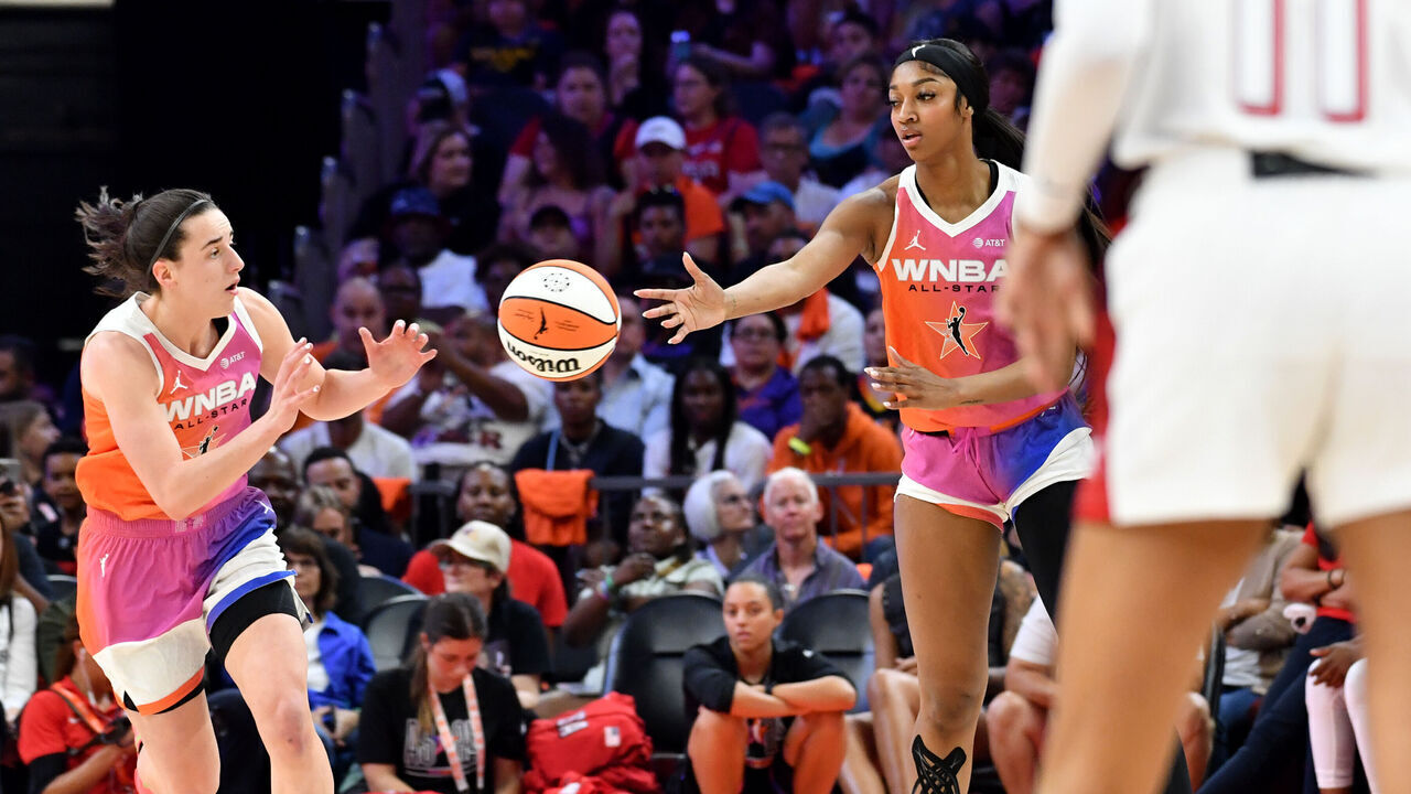 PHOENIX, AZ - JULY 20: Angel Reese #5 bases the ball to Caitlin Clark #22 of Team WNBA during the 2024 WNBA All Star Game on July 20, 2024 at Footprint Center in Phoenix, Arizona. Mandatory Copyright Notice: Copyright 2024 NBAE