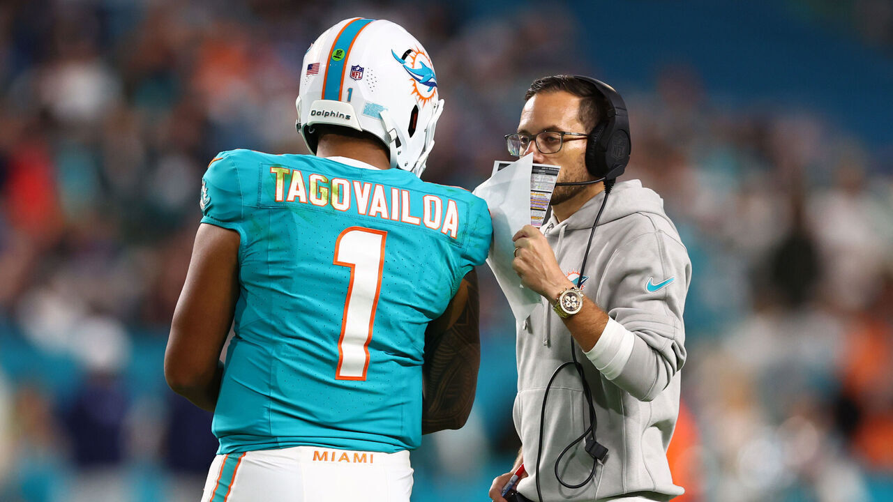 MIAMI GARDENS, FLORIDA - DECEMBER 11: Tua Tagovailoa #1 and head coach Mike McDaniel of the Miami Dolphins speak on the field during the fourth quarter of the game against the Tennessee Titans at Hard Rock Stadium on December 11, 2023 in Miami Gardens, Florida.