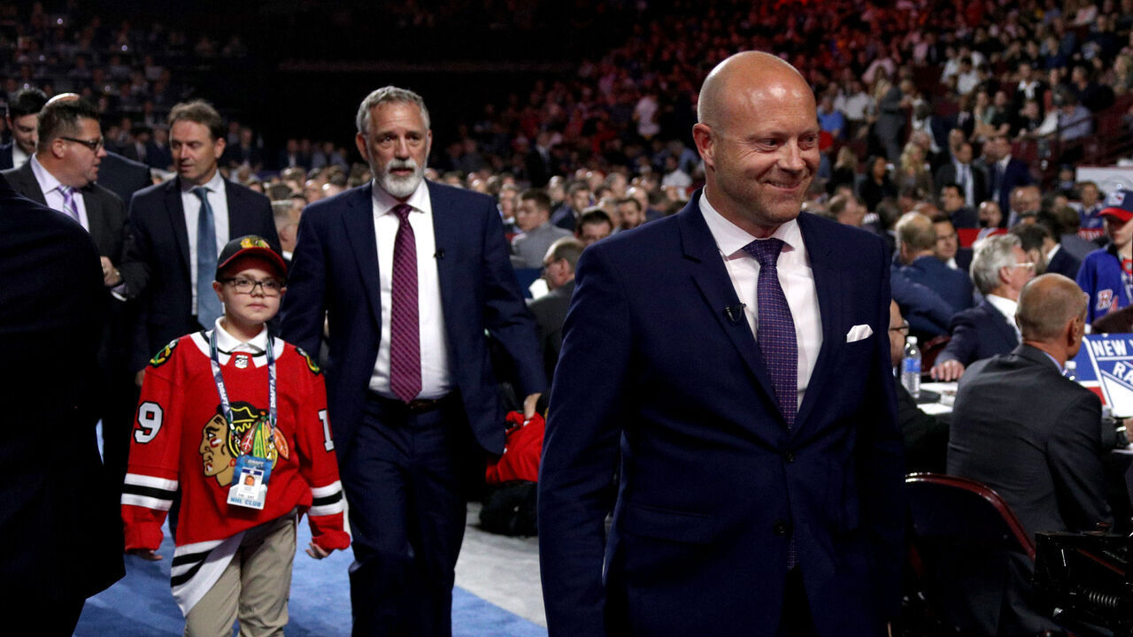 VANCOUVER, BRITISH COLUMBIA - JUNE 21: General Manager Stan Bowman (R) of the Chicago Blackhawks and team personnel walk to the stage to make their third overall pick during the first round of the 2019 NHL Draft at Rogers Arena on June 21, 2019 in Vancouver, Canada.