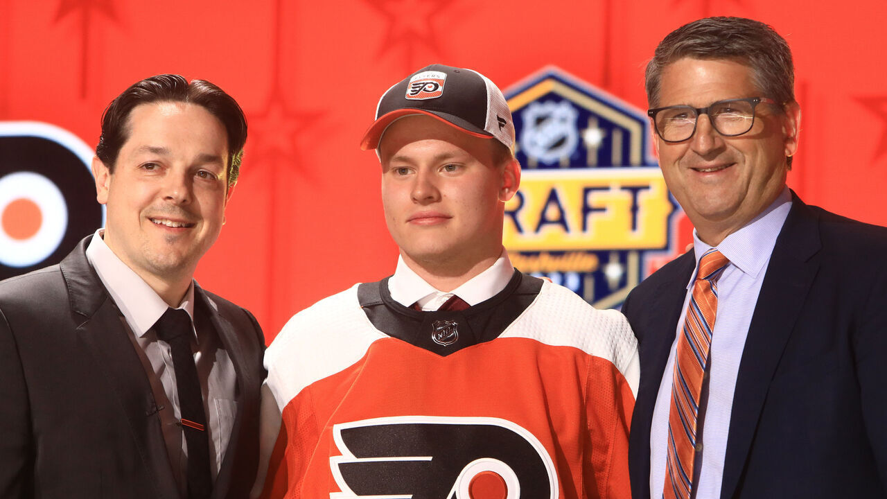NASHVILLE, TN - JUNE 28: Matvei Michkov is shown with Daniel Briere and Keith Jones during the first round of the 2023 Upper Deck NHL Draft, held on June 28, 2023, at Bridgestone Arena in Nashville, Tennessee.