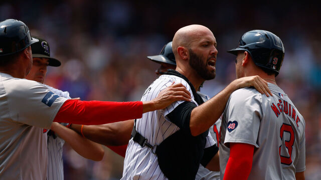 DENVER, CO - JULY 24: Catcher Jacob Stallings #25 of the Colorado Rockies (C) separates starting pitcher Cal Quantrill #47 of the Colorado Rockies and Reese McGuire #3 of the Boston Red Sox during an argument between players during the fourth inning at Coors Field on July 24, 2024 in Denver, Colorado.