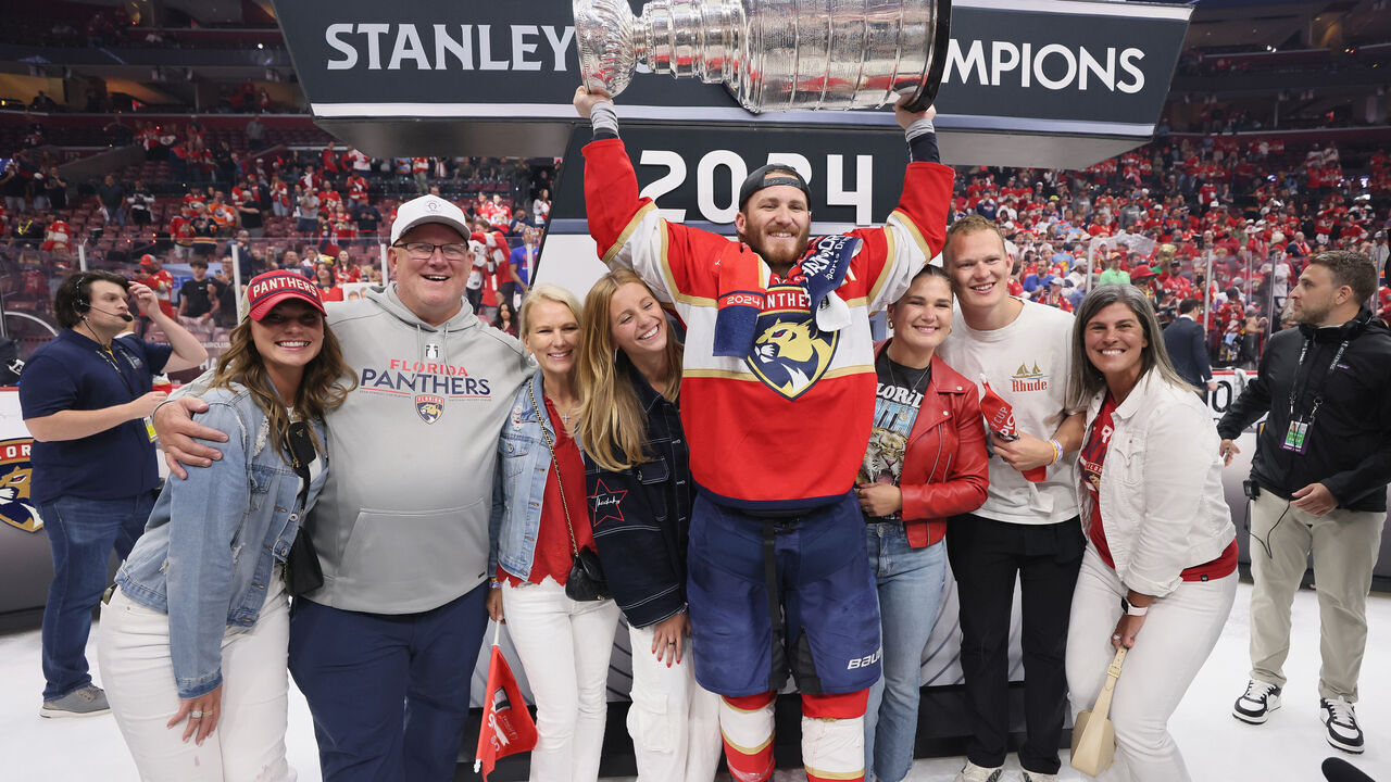 SUNRISE, FLORIDA - JUNE 24: The Tkachuk family celebrates with the Stanley Cup following a 2-1 victory over the Edmonton Oilers in Game Seven of the 2024 NHL Stanley Cup Final at Amerant Bank Arena on June 24, 2024 in Sunrise, Florida.