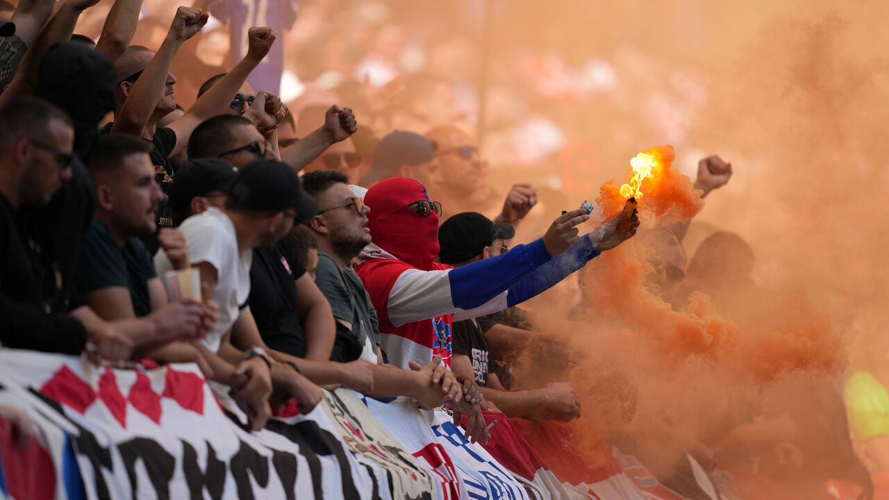 HAMBURG, GERMANY - JUNE 19: Fans of Croatia use an orange smoke flare during the UEFA EURO 2024 group stage match between Croatia and Albania at Volksparkstadion on June 19, 2024 in Hamburg, Germany.