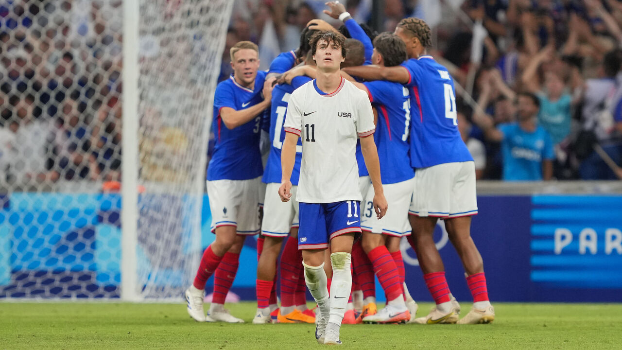 MARSEILLE, FRANCE - JULY 24: Paxten Aaronson #11 of the United States reacts as Michael Olise #7 of France celebrates scoring with teammates during the second half of the Men's group A match between France and United States during the Olympic Games Paris 2024 at Stade de Marseille on July 24, 2024 in Marseille, France.