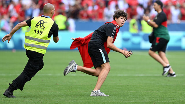 SAINT-ETIENNE, FRANCE - JULY 24: A pitch invader is chased by a steward during the Men's group B match between Argentina and Morocco during the Olympic Games Paris 2024 at Stade Geoffroy-Guichard on July 24, 2024 in Saint-Etienne, France.