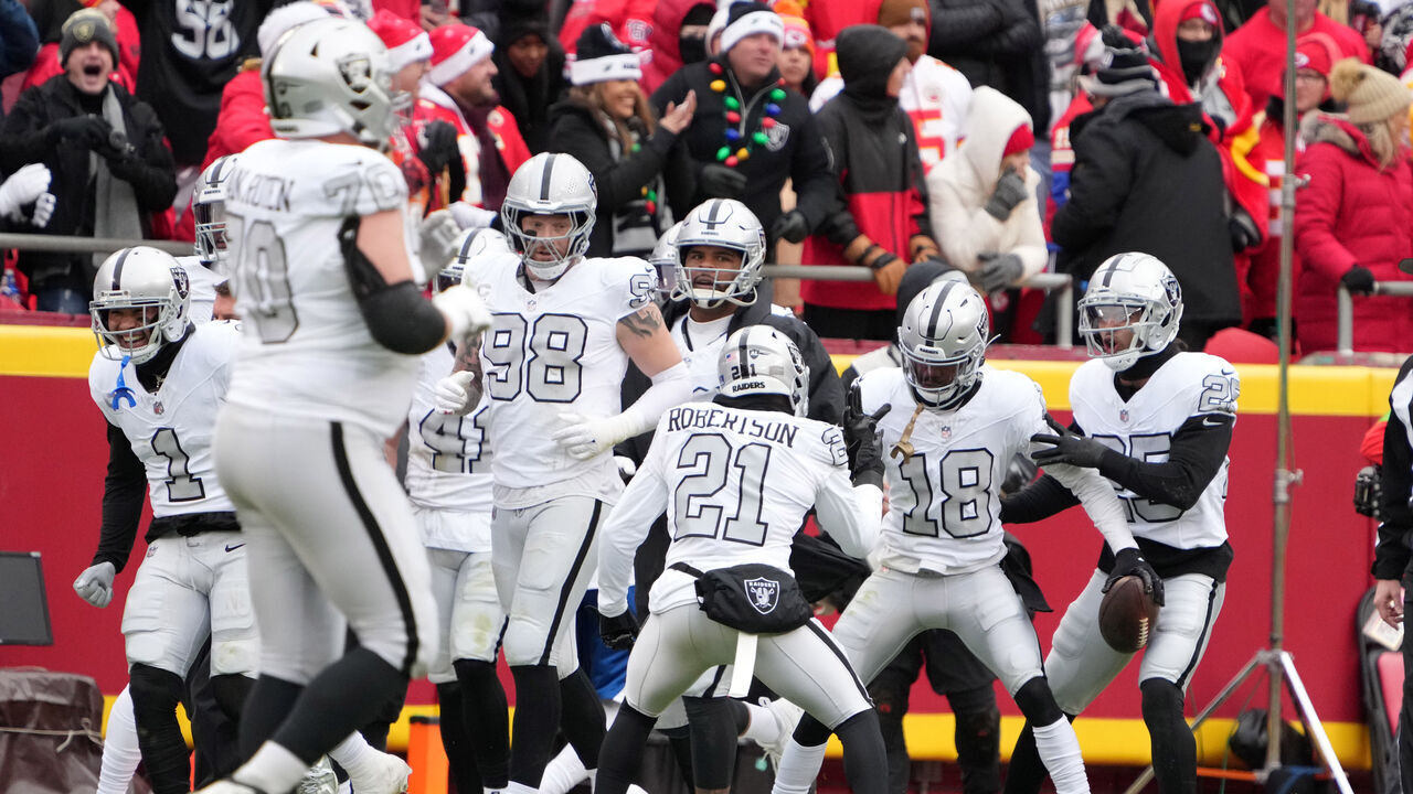 KANSAS CITY, MISSOURI - DECEMBER 25: Las Vegas Raiders cornerback Jack Jones (18) celebrates with cornerback Amik Robertson (21) after scoring a touchdown on an 8-yard fumble recovery in the first half against the Kansas City Chiefs during an NFL football game on December 25, 2023 in Kansas City, Missouri. The Raiders defeated the Chiefs 20-14.