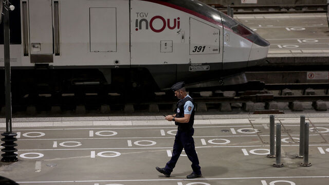 A French gendarme walks on a platform near an InOui high-speed TGV train at the Gare Montparnasse train station in Paris on July 26, 2024 as France's high-speed rail network was hit by malicious acts disrupting the transport system hours before the opening ceremony of the Paris 2024 Olympic Games. According to SNCF a massive attack on a large scale hit the TGV network and many routes will have to be cancelled. SNCF urged passengers to postpone their trips and stay away from train stations.