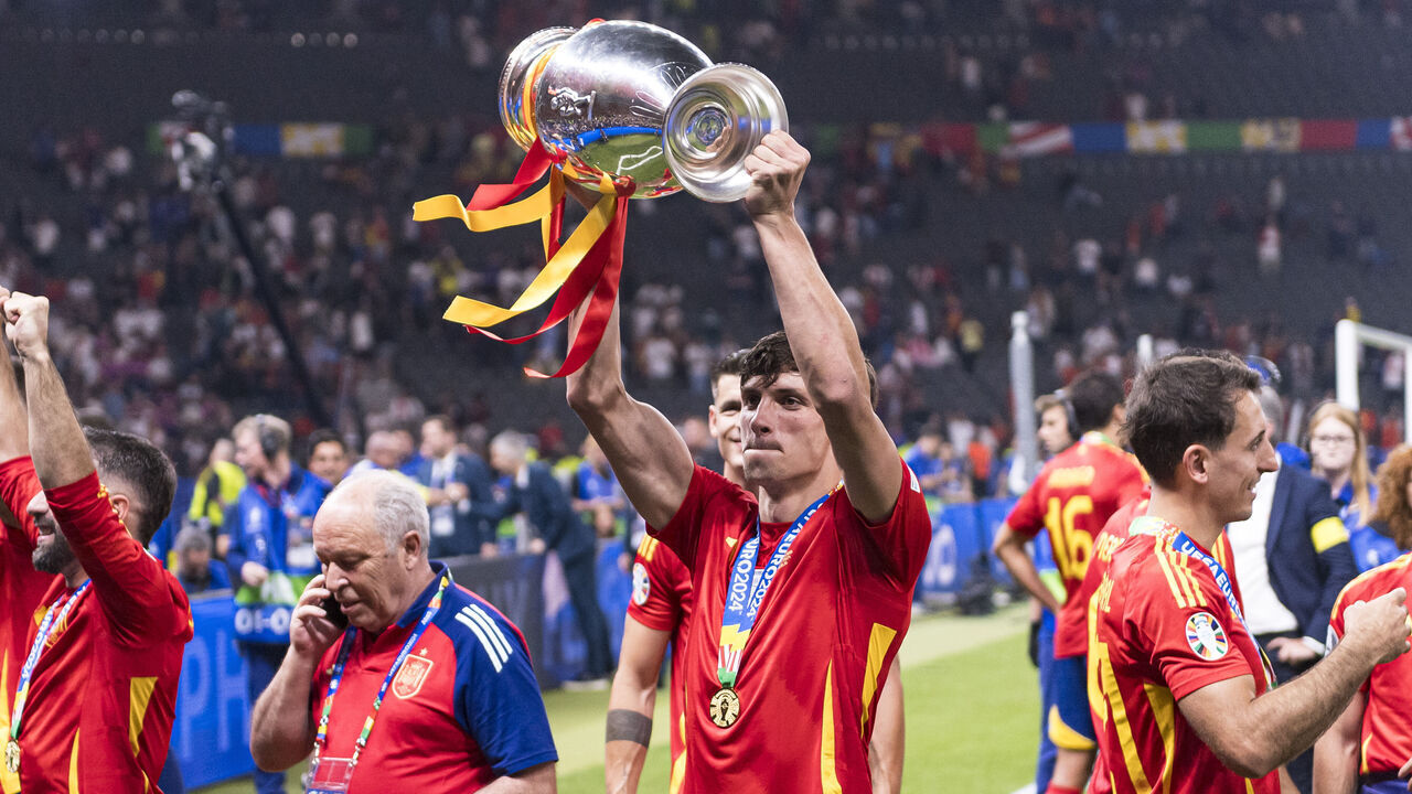 BERLIN, GERMANY - JULY 14: Robin Le Normand of Spain lifts the UEFA Euro 2024 Winners Trophy in celebration after winning against England during the UEFA EURO 2024 final match between Spain and England at Olympiastadion on July 14, 2024 in Berlin, Germany.
