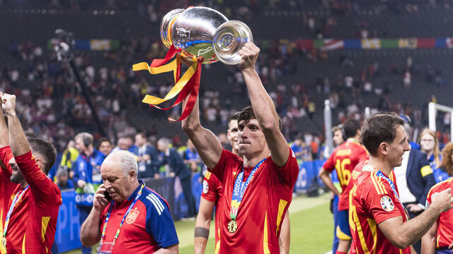 BERLIN, GERMANY - JULY 14: Robin Le Normand of Spain lifts the UEFA Euro 2024 Winners Trophy in celebration after winning against England during the UEFA EURO 2024 final match between Spain and England at Olympiastadion on July 14, 2024 in Berlin, Germany.