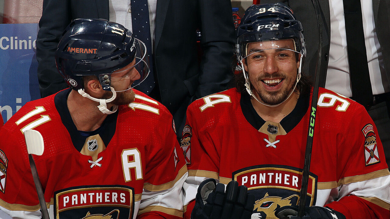 SUNRISE, FL - MARCH 3: Jonathan Huberdeau #11 and teammate Ryan Lomberg #94 of the Florida Panthers enjoy each others company between shifts against the Ottawa Senators at the FLA Live Arena on March 3, 2022 in Sunrise, Florida.