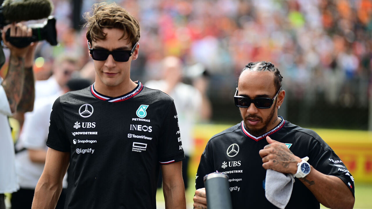 George Russell of Mercedes-AMG Petronas and Lewis Hamilton of Mercedes-AMG Petronas F1 Team are walking during the drivers' parade of the Hungarian GP, the 13th race of the Formula 1 World Championship in Hungaroring, Mogyorod, Kosice, Hungary, on July 21, 2024.
