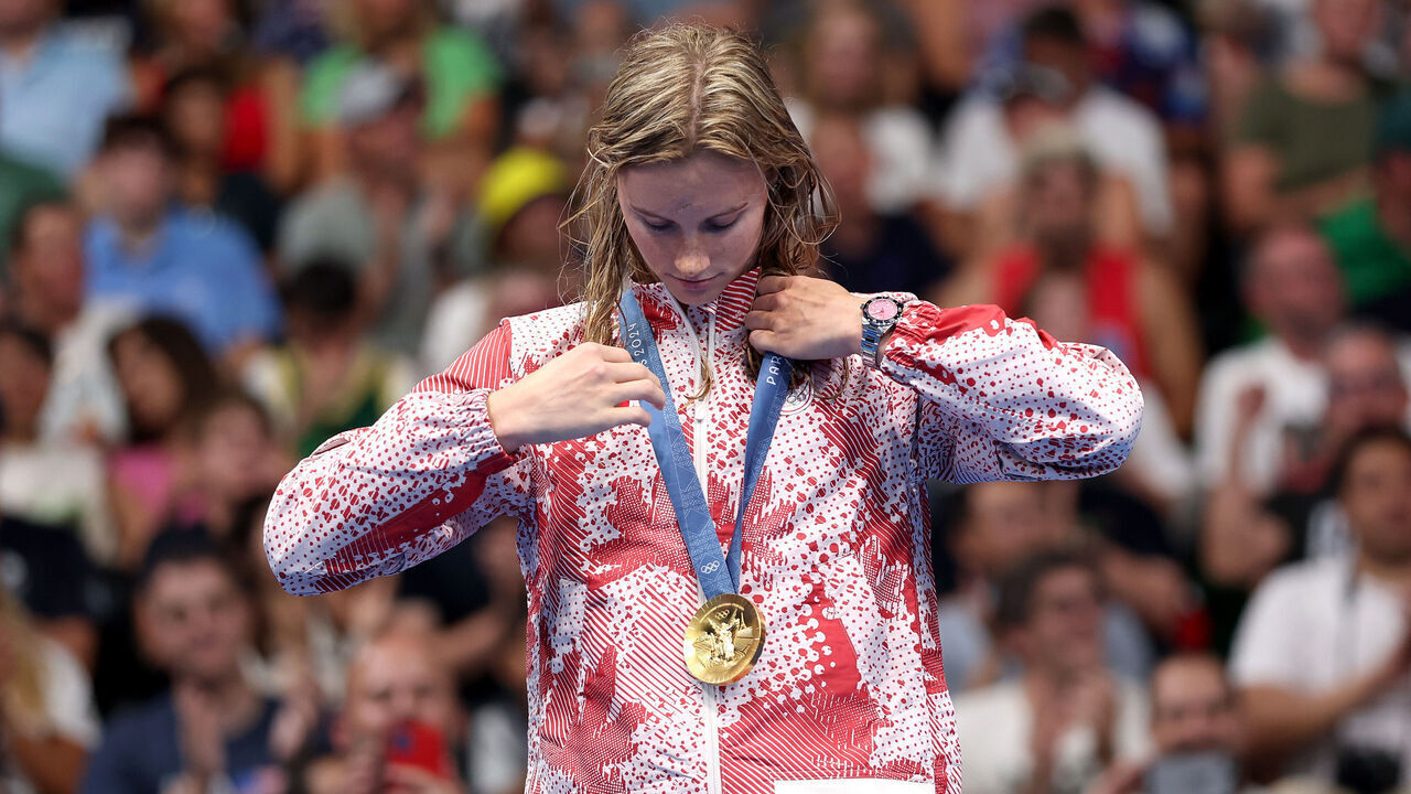 NANTERRE, FRANCE - JULY 29: Gold Medalist Summer McIntosh of Team Canada adjusts her medal on the podium during the Swimming medal ceremony after the Women’s 400m Individual Medley Final on day three of the Olympic Games Paris 2024 at Paris La Defense Arena on July 29, 2024 in Nanterre, France.