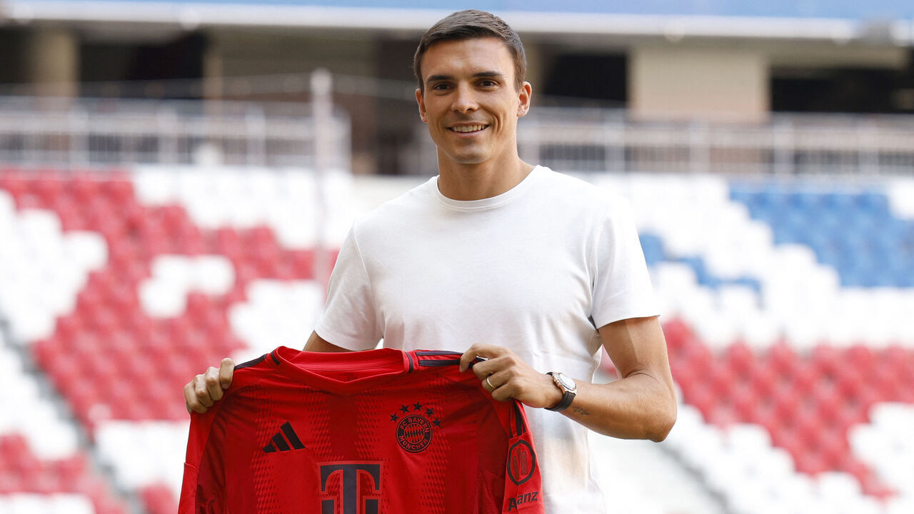 FC Bayern Munich's new Portugese midfielder Joao Palhinha holds his tricot in the Allianz Arena stadium after his presentation's press conference in Munich, southern Germany, on July 30, 2024.