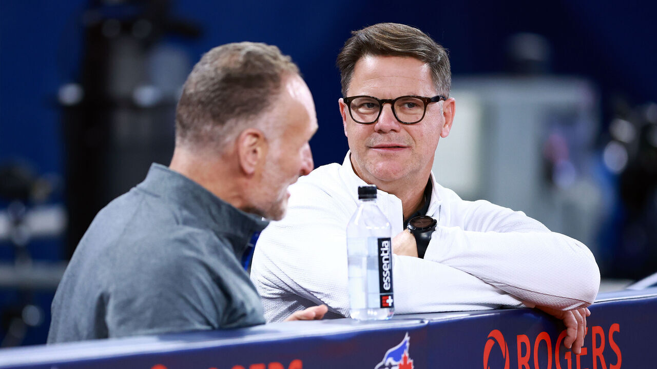 TORONTO, ON - APRIL 16: Ross Atkins, Toronto Blue Jays Executive Vice President, Baseball Operations & General Manager speaks with Mark Shapiro, Toronto Blue Jays President & CEO in the dugout, prior to a game against the New York Yankees at Rogers Centre on April 16, 2024 in Toronto, Ontario, Canada.