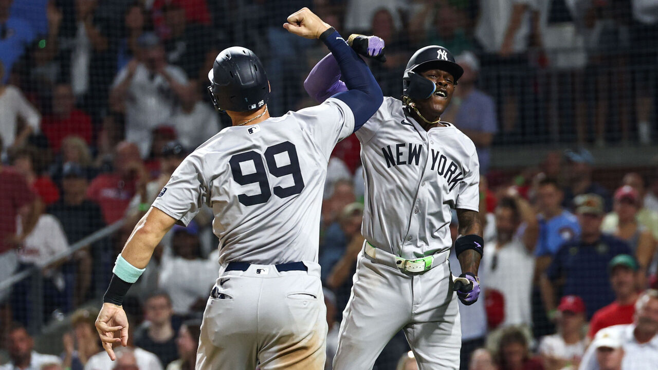 PHILADELPHIA, PENNSYLVANIA - JULY 30: Jazz Chisholm Jr. #13 of the New York Yankees celebrates with Aaron Judge #99 after hitting a three-run home run against the Philadelphia Phillies in the seventh inning at Citizens Bank Park on July 30, 2024 in Philadelphia, Pennsylvania.