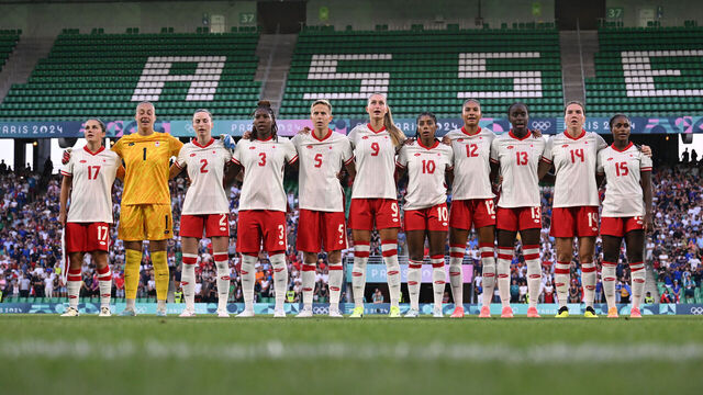 SAINT-ETIENNE, FRANCE - JULY 28: Team Canada sing their national anthem on pitch ahead of the Women's group A match between France and Canada during the Olympic Games Paris 2024 at Stade Geoffroy-Guichard on July 28, 2024 in Saint-Etienne, France.
