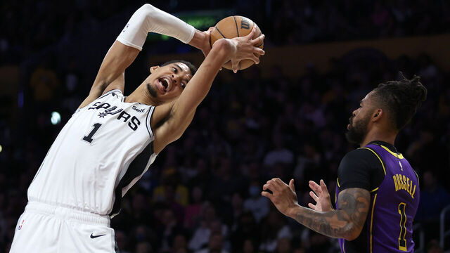 LOS ANGELES, CALIFORNIA - FEBRUARY 23: Victor Wembanyama #1 of the San Antonio Spurs rebounds against D'Angelo Russell #1 of the Los Angeles Lakers during the first half of a game at Crypto.com Arena on February 23, 2024 in Los Angeles, California.