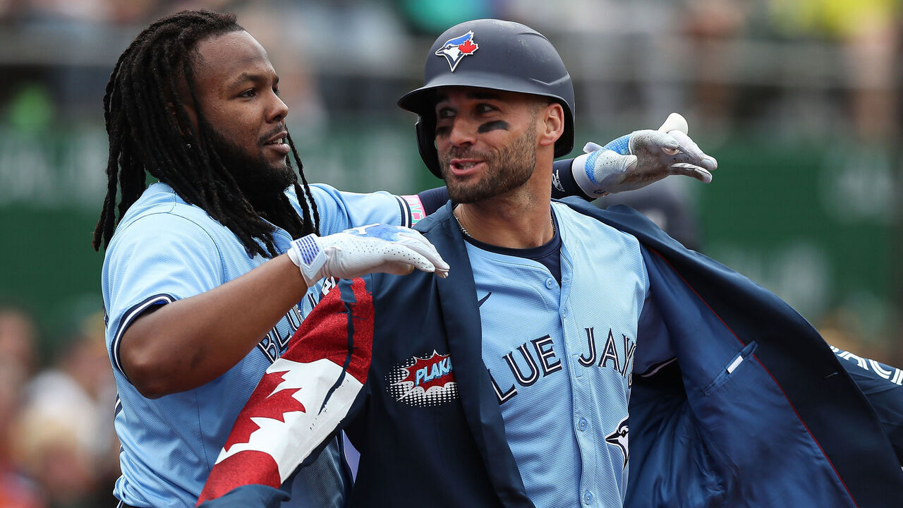 OAKLAND, CALIFORNIA - JUNE 8: Vladimir Guerrero #27 of the Toronto Blue Jays celebrates by putting a jacket on teammate Kevin Kiermaier #39 after Kermaier hit a home run against the Oakland Athletics in the top of the fifth inning at Oakland Coliseum on June 8, 2024 in Oakland, California.