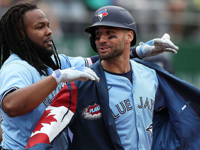 OAKLAND, CALIFORNIA - JUNE 8: Vladimir Guerrero #27 of the Toronto Blue Jays celebrates by putting a jacket on teammate Kevin Kiermaier #39 after Kermaier hit a home run against the Oakland Athletics in the top of the fifth inning at Oakland Coliseum on June 8, 2024 in Oakland, California.