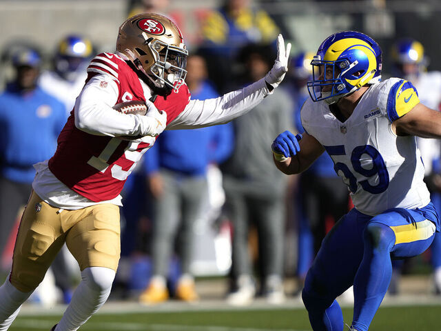 SANTA CLARA, CALIFORNIA - JANUARY 07: Deebo Samuel #19 of the San Francisco 49ers running with the ball fights off the tackle of Troy Reeder #59 of the Los Angeles Rams during the first quarter of an NFL football game at Levi's Stadium on January 07, 2024 in Santa Clara, California.