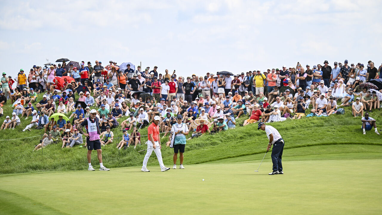PARIS, FRANCE - AUGUST 01: Hideki Matsuyama of Team Japan makes a par putt on the 17th hole green as fans look on during the first round of the Olympic men's golf competition on day six of the Olympic Games Paris 2024 at Le Golf National on August 1, 2024 in Saint-Quentin-en-Yvelines, France.