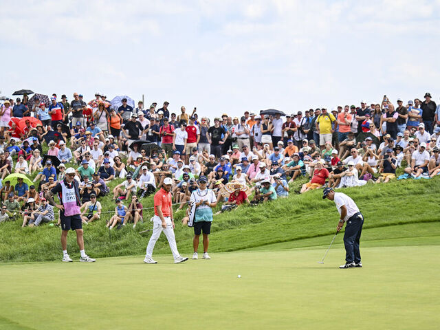 PARIS, FRANCE - AUGUST 01: Hideki Matsuyama of Team Japan makes a par putt on the 17th hole green as fans look on during the first round of the Olympic men's golf competition on day six of the Olympic Games Paris 2024 at Le Golf National on August 1, 2024 in Saint-Quentin-en-Yvelines, France.