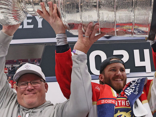 SUNRISE, FLORIDA - JUNE 24: The Tkachuk family celebrates with the Stanley Cup following a 2-1 victory over the Edmonton Oilers in Game Seven of the 2024 NHL Stanley Cup Final at Amerant Bank Arena on June 24, 2024 in Sunrise, Florida.