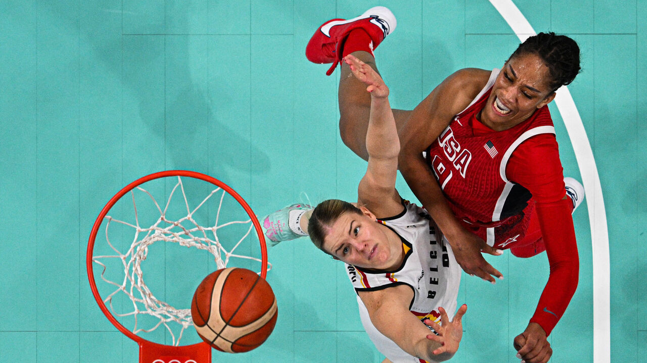 An overview shows Belgium's #25 Becky Massey (L) and USA's #09 A'ja Wilson go for a rebound in the women's preliminary round group C basketball match between Belgium and USA during the Paris 2024 Olympic Games at the Pierre-Mauroy stadium in Villeneuve-d'Ascq, northern France, on August 1, 2024.