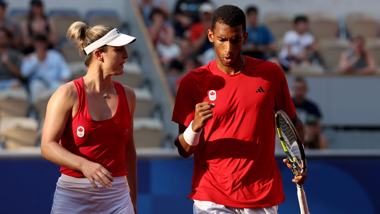 PARIS, FRANCE - AUGUST 02: Gabriela Dabrowski and Felix Auger-Aliassime of Team Canada celebrate during the Tennis Mixed Doubles Bronze Medal match against Demi Schuurs and Wesley Koolhof of Team Netherlands on day seven of the Olympic Games Paris 2024 at Roland Garros on August 02, 2024 in Paris, France.