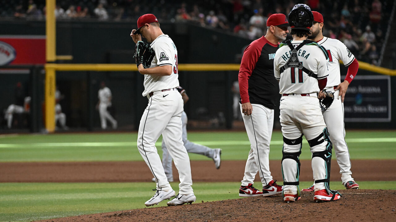 PHOENIX, ARIZONA - JULY 31: Paul Sewald #38 of the Arizona Diamondbacks is relieved during the ninth inning of a game against the Washington Nationals at Chase Field on July 31, 2024 in Phoenix, Arizona. The Diamondbacks won 5-4.