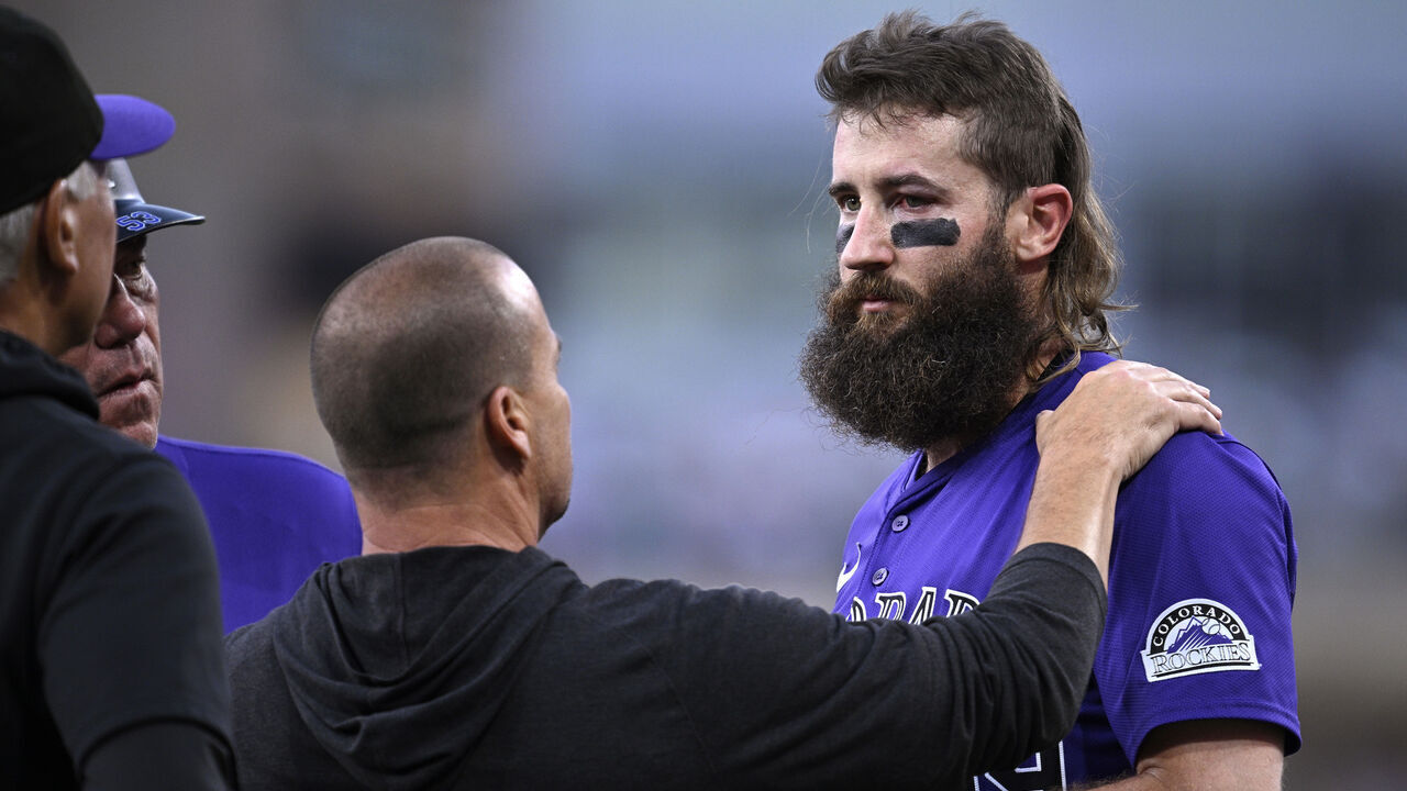 SAN DIEGO, CALIFORNIA - AUGUST 02: Charlie Blackmon #19 of the Colorado Rockies is checked by a trainer after being hit by a ball in the third inning of the game against the San Diego Padres at Petco Park on August 02, 2024 in San Diego, California.