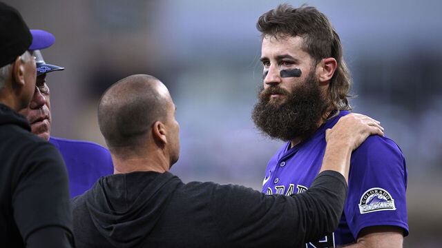 SAN DIEGO, CALIFORNIA - AUGUST 02: Charlie Blackmon #19 of the Colorado Rockies is checked by a trainer after being hit by a ball in the third inning of the game against the San Diego Padres at Petco Park on August 02, 2024 in San Diego, California.