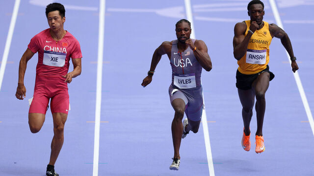 PARIS, FRANCE - AUGUST 03: Zhenye Xie of Team People's Republic of China, Noah Lyles and Owen Ansah of Team Germany of Team United States competes on during the Men's 100m Round 1 on day eight of the Olympic Games Paris 2024 at Stade de France on August 03, 2024 in Paris, France.