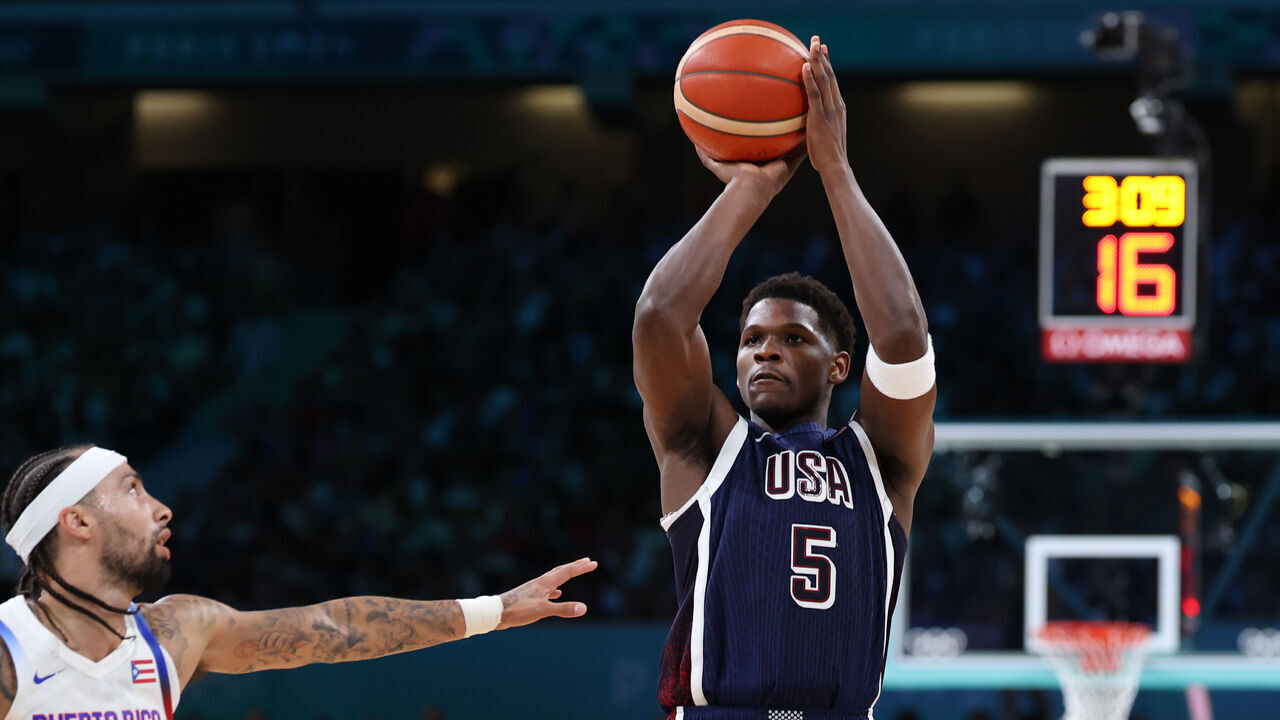 LILLE, FRANCE - AUGUST 03: Anthony Edwards #5 of Team United States shoots over Jose Alvarado #10 of Team Puerto Rico during a Men's basketball group phase-group C game between the United States and Puerto Rico on day eight of the Olympic Games Paris 2024 at Stade Pierre Mauroy on August 03, 2024 in Lille, France.