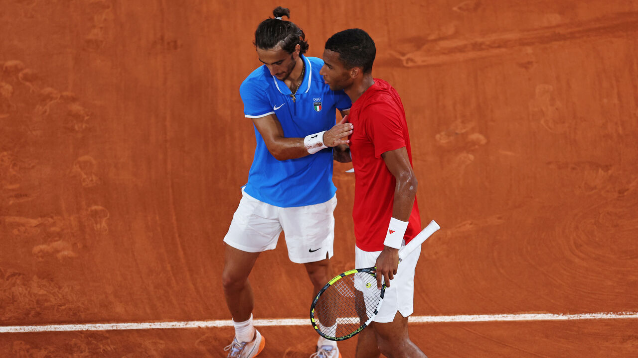 PARIS, FRANCE - AUGUST 03: Felix Auger-Aliassime of Team Canada (R) congratulates Lorenzo Musetti of Team Italy following the Tennis Men's Singles Bronze medal match on day eight of the Olympic Games Paris 2024 at Roland Garros on August 03, 2024 in Paris, France.