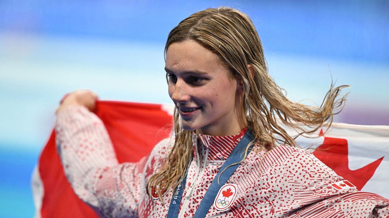 Gold medallist Canada's Summer Mcintosh celebrates during the podium ceremony of the women's 200m individual medley swimming event during the Paris 2024 Olympic Games at the Paris La Defense Arena in Nanterre, west of Paris, on August 3, 2024.
