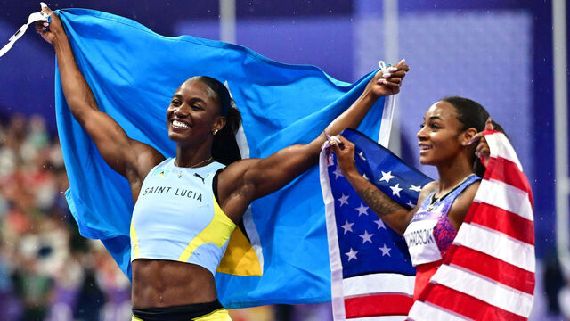 PARIS, FRANCE - AUGUST 03: Julien Alfred of Team Saint Lucia (L) celebrates winning gold during the Women's 100m Final on day eight of the Olympic Games Paris 2024 at Stade de France on August 03, 2024 in Paris, France.Photo by Christian Liewig - Corbis/Corbis via Getty Images)