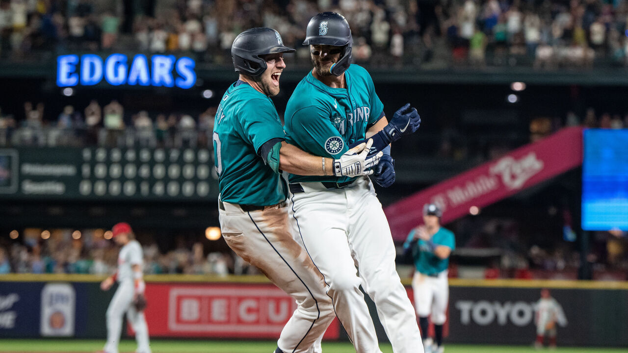 SEATTLE, WA - AUGUST 03: Mitch Haniger #17 of the Seattle Mariners celebrates with Luke Raley #20 after earning a walk-off walk to end a game against the Philadelphia Phillies at T-Mobile Park on August 3, 2024 in Seattle, Washington. The Mariners won 6-5 in ten innings.
