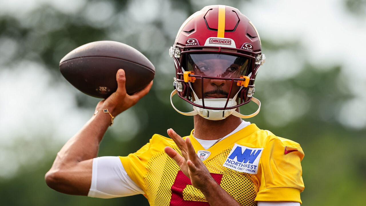 ASHBURN, VA - JULY 25: Jayden Daniels #5 of the Washington Commanders attempts a pass during training camp at OrthoVirginia Training Center at Commanders Park on July 25, 2024 in Ashburn, Virginia.