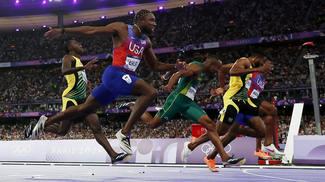 PARIS, FRANCE - AUGUST 04: Noah Lyles of Team United States crosses the finish line during the Men's 100m Final on day nine of the Olympic Games Paris 2024 at Stade de France on August 04, 2024 in Paris, France.