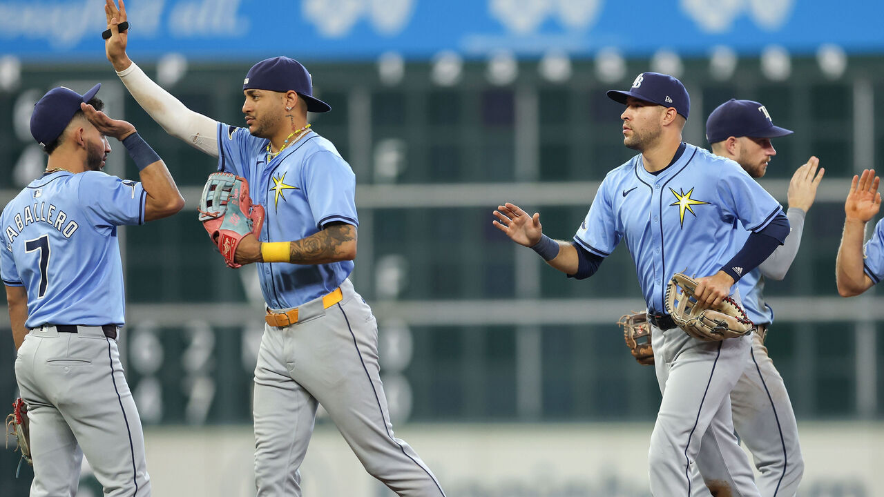 HOUSTON, TEXAS - AUGUST 04: Jose Siri #22 of the Tampa Bay Rays (2nd from L) and Dylan Carlson #10 (3rd from R) celebrate with teammates after the game against the Houston Astros at Minute Maid Park on August 04, 2024 in Houston, Texas.