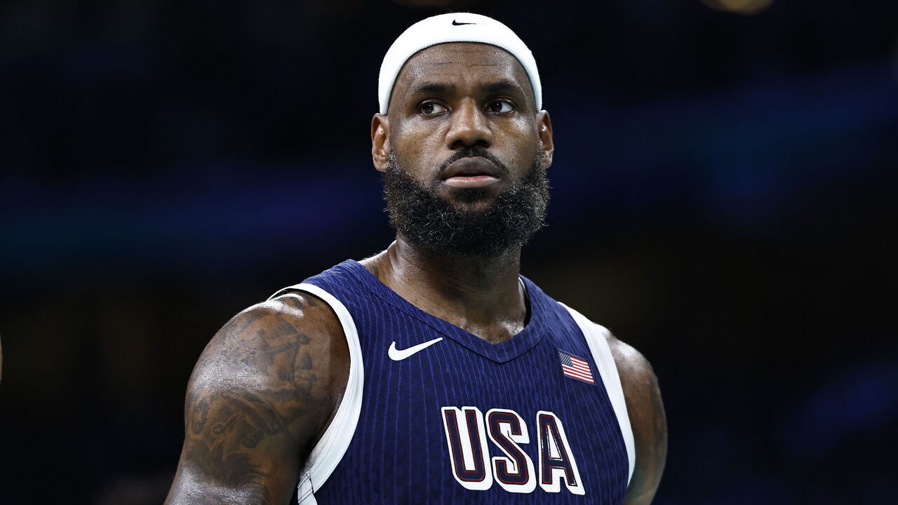 TOPSHOT - USA's #06 LeBron James reacts in the men's preliminary round group C basketball match between Puerto Rico and USA during the Paris 2024 Olympic Games at the Pierre-Mauroy stadium in Villeneuve-d'Ascq, northern France, on August 3, 2024.