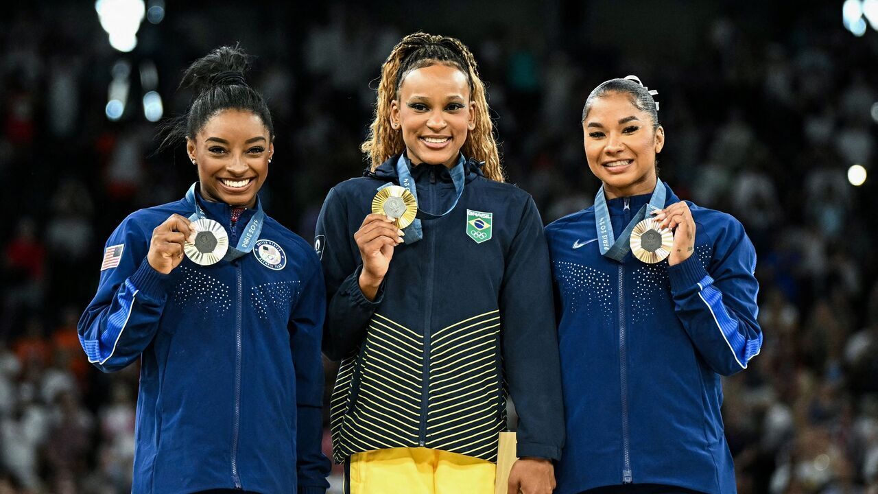 (LtoR) US' Simone Biles (silver), Brazil's Rebeca Andrade (gold) and US' Jordan Chiles (bronze) pose during the podium ceremony for the artistic gymnastics women's floor exercise event of the Paris 2024 Olympic Games at the Bercy Arena in Paris, on August 5, 2024.