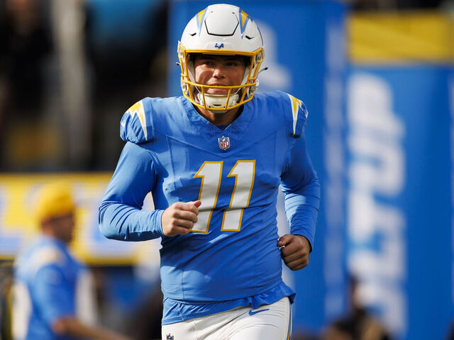 INGLEWOOD, CALIFORNIA - JANUARY 07: Cameron Dicker #11 of the Los Angeles Chargers runs out during player introductions before an NFL football game against the Kansas City Chiefs at SoFi Stadium on January 7, 2024 in Inglewood, California.