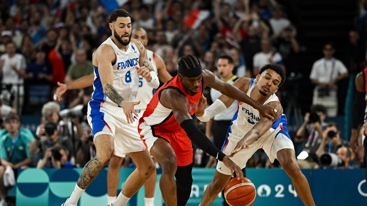PARIS, FRANCE - AUGUST 06: Shai Gilgeous-Alexander of Canada (C) in action with Victor Wembanyama of France (R) and Isaia Cordinier of France during the Men's Basketball Quarterfinal match between France and Canada on day eleven of the Olympic Games Paris 2024 at Bercy Arena on August 06, 2024 in Paris, France.