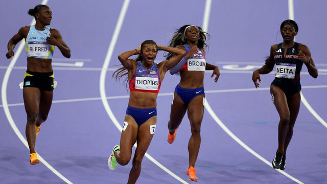 PARIS, FRANCE - AUGUST 06: Gold medalist Gabrielle Thomas of Team United States (2nd L) celebrates after winning in the Women's 200m Final on day eleven of the Olympic Games Paris 2024 at Stade de France on August 06, 2024 in Paris, France.