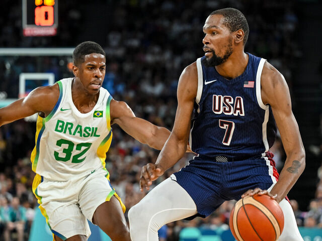 Georginho de Paula of Brazil and Kevin Durant of USA battle for the ball during the Men's Basketball Quarterfinal match between Brazil and United State on Day 11 of the Olympic Games Paris 2024 at Bercy Arena on August 6, 2024 in Paris, France.