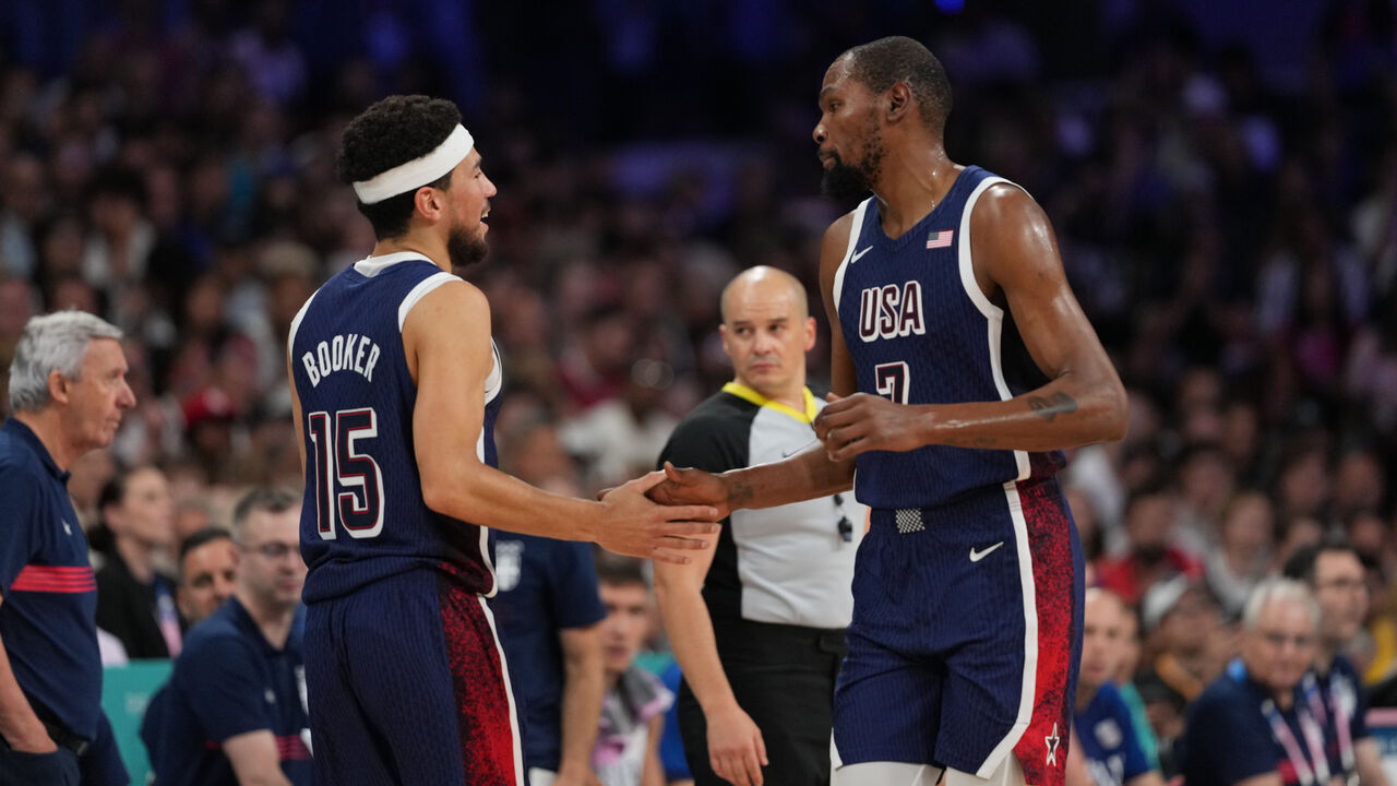 LILLE, FRANCE - JULY 28: Devin Booker #15 and Kevin Durant #7 of Team USA high five during the game against the Serbian Men's National Team on July 28, 2024 at the Stade Pierre Mauroy in Paris, France. NOTE TO USER: User expressly acknowledges and agrees that, by downloading and/or using this photograph, user is consenting to the terms and conditions of the Getty Images License Agreement. Mandatory Copyright Notice: Copyright 2024 NBAE