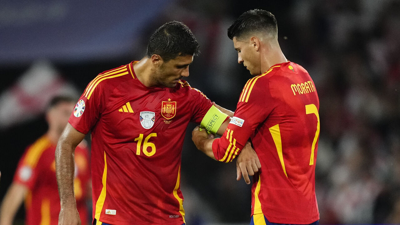Alvaro Morata centre-forward of Spain and Atletico de Madrid gives the captain's armband to Rodrigo Hernandez defensive midfield of Spain and Manchester City during the UEFA EURO 2024 round of 16 match between Spain and Georgia at Cologne Stadium on June 30, 2024 in Cologne, Germany.
