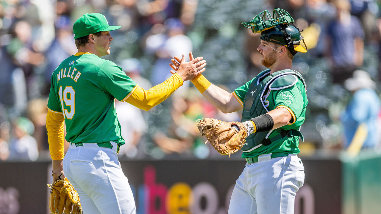 OAKLAND, CA - AUGUST 07: Oakland Athletics pitcher Mason Miller (19) celebrates with Oakland Athletics catcher Kyle McCann (52) after the professional MLB baseball game between the Chicago White Sox and the Oakland Athletics on August 7, 2024 at the Oakland-Alameda County Coliseum in Oakland, CA.